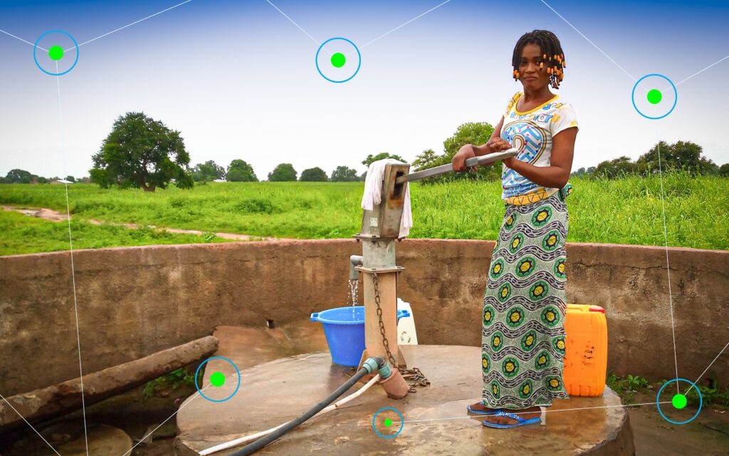 Woman collecting water at borehole in the Gambia